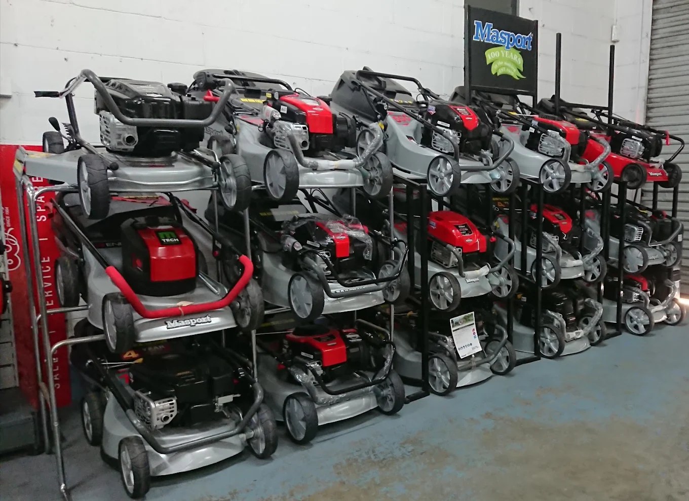 Masport mowers racked on the AG Mowers shop floor